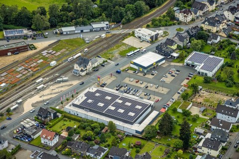 Aerial view, Bahnhofstrasse shopping centre with Rewe supermarket and solar roof, Takko fashion and