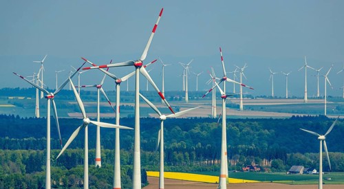 Aerial view, wind park and wind farm wind energy plant, wind turbines and rape fields near