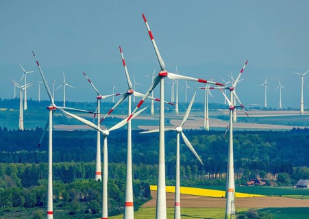Aerial view, wind park and wind farm wind energy plant, wind turbines and rape fields near