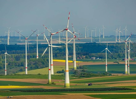 Aerial view, wind park and wind farm wind energy plant, wind turbines and rape fields near