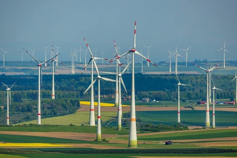 Aerial view, wind park and wind farm wind energy plant, wind turbines and rape fields near