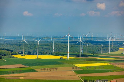 Aerial view, wind park and wind farm wind energy plant, wind turbines and rape fields near