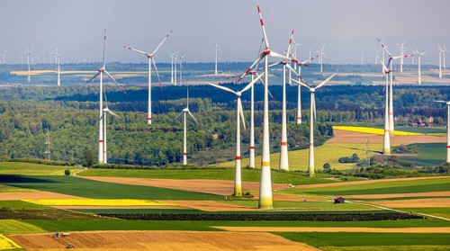 Aerial view, wind park and wind farm wind energy plant, wind turbines and rape fields near