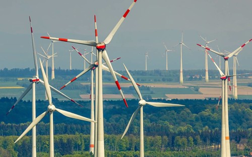 Aerial view, wind park and wind farm wind energy plant, wind turbines and rape fields near
