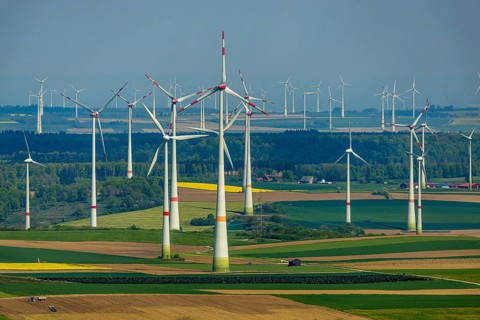 Aerial view, wind park and wind farm wind energy plant, wind turbines and rape fields near