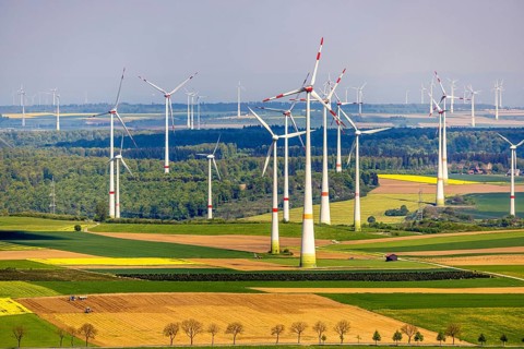 Aerial view, wind park and wind farm wind energy plant, wind turbines and rape fields near