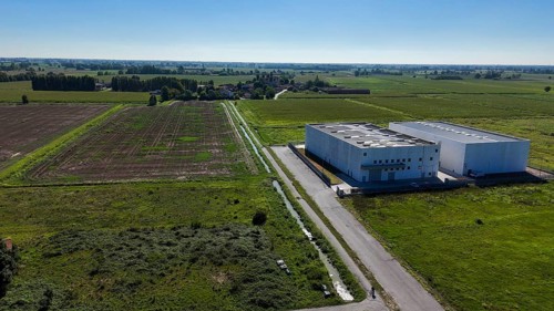 Modern data center facility situated in a rural landscape of Lombardy Italy surrounded by