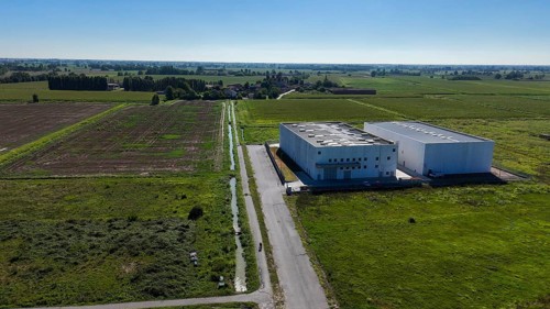 Cremona, Italy - August 22nd 2025 Modern data center facility under a clear blue sky surrounded by