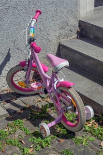 Pink-coloured Unicorn children's bike with training wheels, Dornbirn, Vorarlberg, Austria