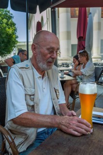 Elderly man with beard holding wheat beer glass, Dornbirn, Vorarlberg, Austria