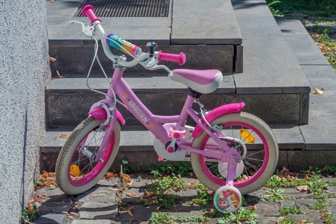 Pink-coloured Unicorn children's bike with training wheels, Dornbirn, Vorarlberg, Austria