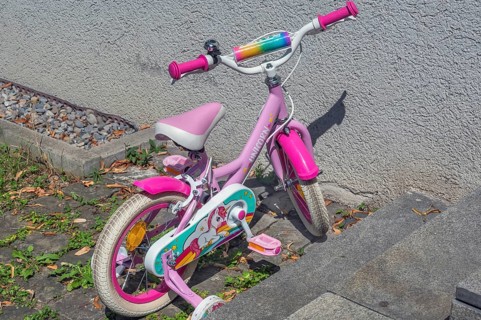 Pink-coloured Unicorn children's bike with training wheels, Dornbirn, Vorarlberg, Austria