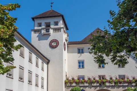 Light grey façade with tower, clock and floral decorations, Dornbirn, Vorarlberg, Austria