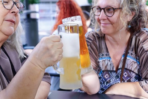 Women enjoying refreshing beer at a pub, celebrating friendship