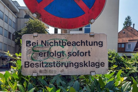 No stopping sign with the notice In the event of non-compliance, immediate action for possession
