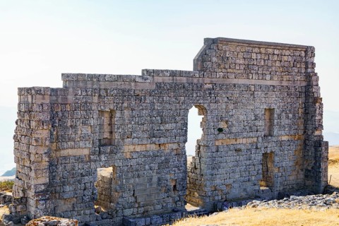 08/21/2025 Ronda, Malaga, Spain Main facade of the ruins of the Roman amphitheater of Acinipo with