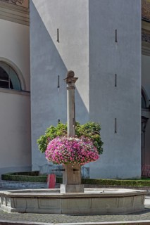 St Martin's Fountain with floral decorations at the parish church of St Martin, Dornbirn,