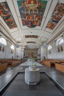 The Roman Catholic parish church of St Martin, interior with altar, ceiling frescoes and baptismal