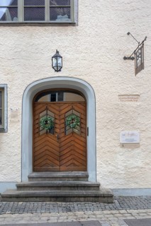 Façade with wooden gate, lantern and ivy wreaths, former residence of the patrician Vogt family,