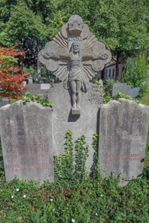 Gravesite with stone crucifix and ivy, catholic cemetery, Kempten, Allgäu, Bavaria, Germany
