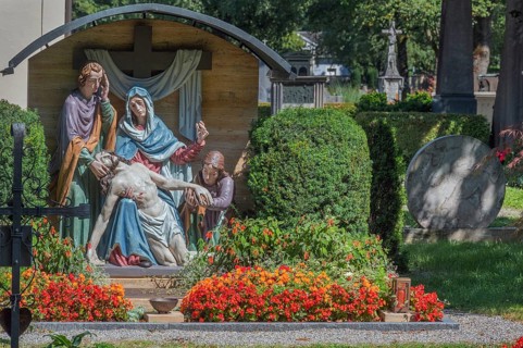 Gravesite with depiction of the Descent from the Cross and floral decoration, Catholic cemetery,