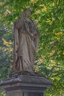 Gravesite with weathered figure of Christ blessing, catholic cemetery, Kempten, Allgäu, Bavaria,