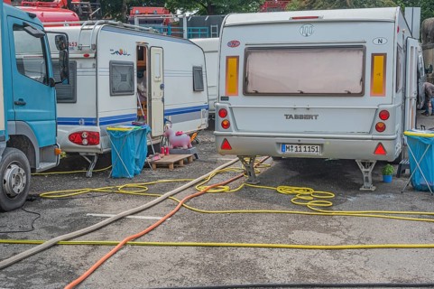 Parked caravans with tangle of water hoses, Circus-Krone, Kempten, Allgäu, Bavaria, Germany