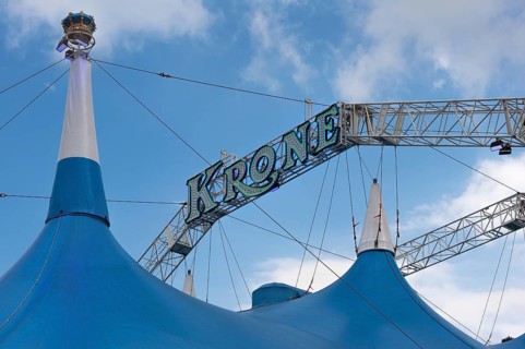 Circus tent, circus tent with large luminous lettering in front of a blue sky, Circus-Krone,