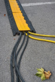 Power cable with cable bridge on asphalt, Circus-Krone, Kempten, Allgäu, Bavaria, Germany