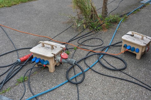 Power cable and power distributor on asphalt, Circus-Krone, Kempten, Allgäu, Bavaria, Germany