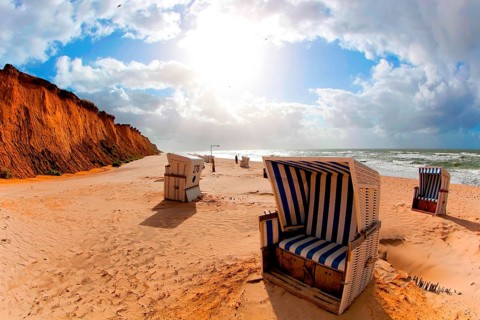 Beach with beach chairs at the Red Cliff near Kampen on Sylt on the North Sea at sunset