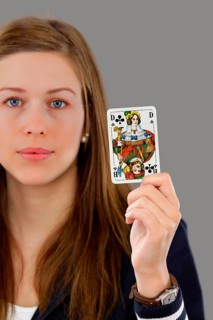 Woman holding a playing card in her hand