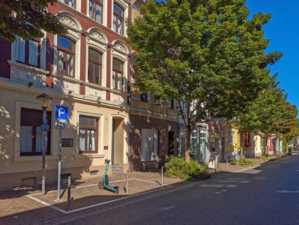 Street in the old town, trees, car park for scooters, e-scooters, blue sky, sunshine, Brühl, North