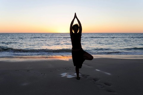 Yoga position, woman showing asana on the beach at Cervantes, Perth, Western Australia, WA, Indian