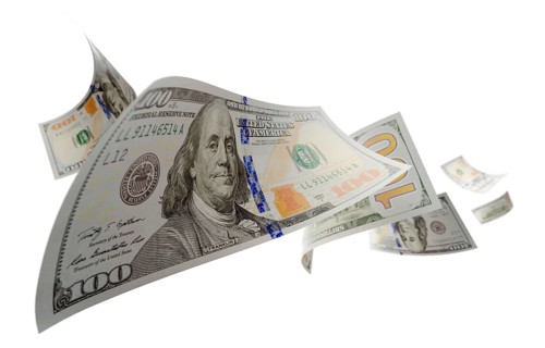 Randomly falling U.S. 100 dollar bills isolated on a white background