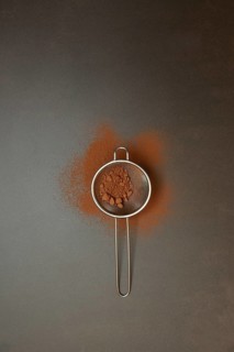 Kitchen sieve with cocoa powder, cocoa