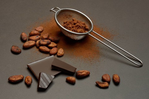 Kitchen sieve with cocoa powder and chocolate, cocoa and cocoa beans