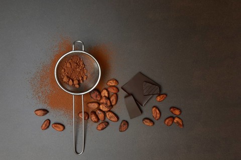 Kitchen sieve with cocoa powder and chocolate, cocoa and cocoa beans