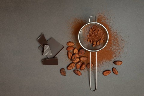 Kitchen sieve with cocoa powder and chocolate, cocoa and cocoa beans