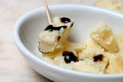 Parmesan cheese, pieces of cheese with crema di balsamico in small bowls