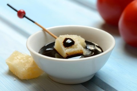 Parmesan cheese, pieces of cheese with crema di balsamico in small bowls