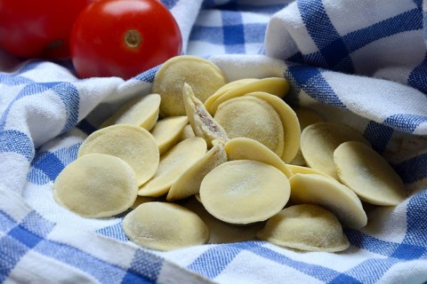Anolini, filled pasta pockets on kitchen towel, pasta variety from Italy, Anolini piacentini