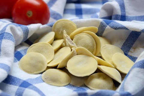 Anolini, filled pasta pockets on kitchen towel, pasta variety from Italy, Anolini piacentini