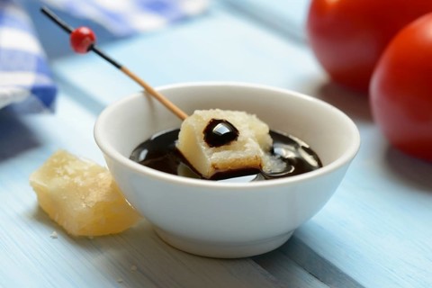 Parmesan cheese, pieces of cheese with crema di balsamico in small bowls