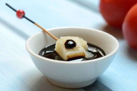 Parmesan cheese, pieces of cheese with crema di balsamico in small bowls