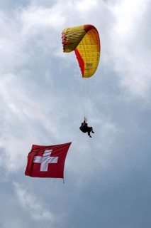 Paragliding tandem flight with Swiss flag, Interlaken, Switzerland