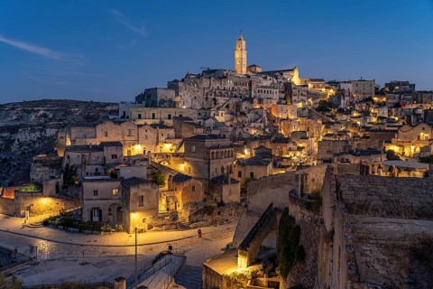 City view of Matera with the Sassi cave settlements and the cathedral at dusk, Matera, Basilicata,