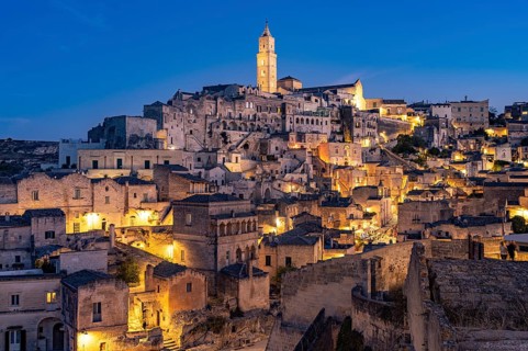 City view of Matera with the Sassi cave settlements and the cathedral at dusk, Matera, Basilicata,