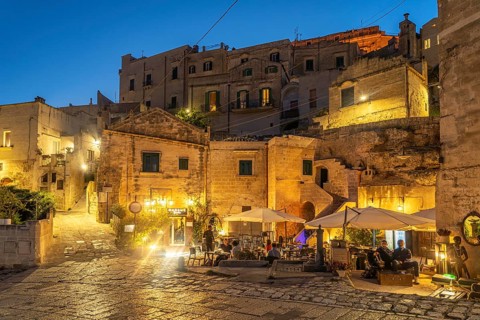 Restaurants in Sasso Barisano at dusk, Matera, Basilicata, Italy