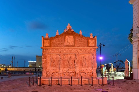 The colourfully illuminated Greek fountain Fontana Greca at dusk, Gallipoli, Apulia, Italy